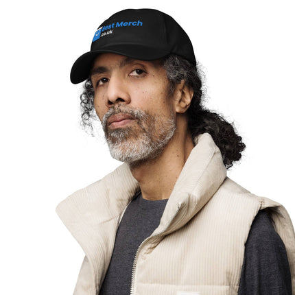 Black Baseball hat - Best Merch Branded modeled by man in beige vest. Premium branded merch cap for versatile fashion appeal.