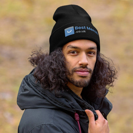 Cuffed Best Merch Beanie in black with logo detail, worn by man outdoors in black jacket. Ideal for casual merch fashion.