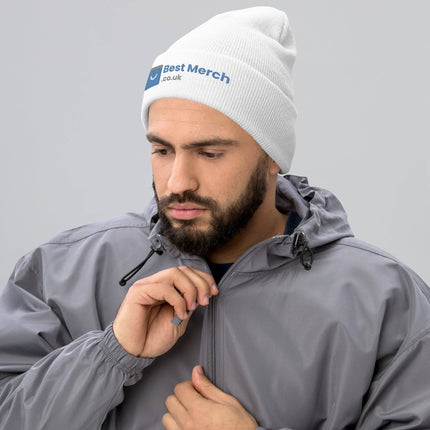 White Cuffed Best Merch Beanie with embroidered logo, modeled by man in gray jacket. Sleek and warm winter merch beanie.