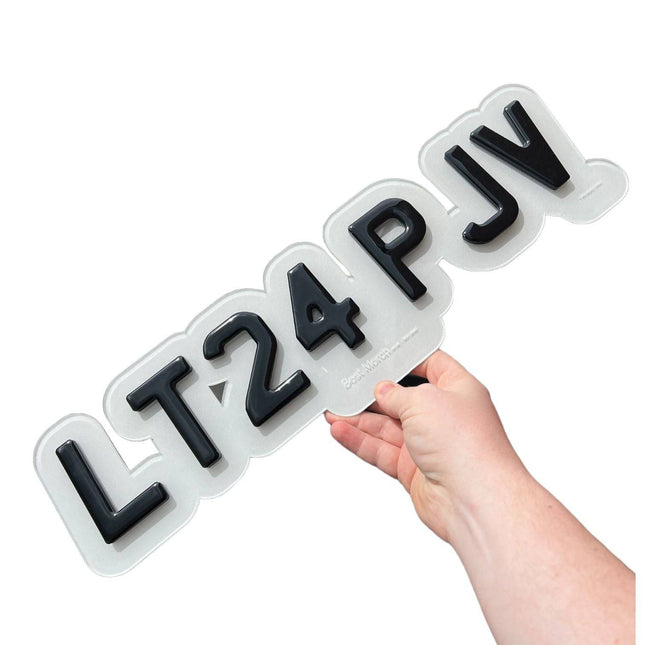 BUBBLE PLATE UPGRADE (FRONT ONLY) featuring raised black 3D letters on a clear acrylic plate, held by hand for size reference.