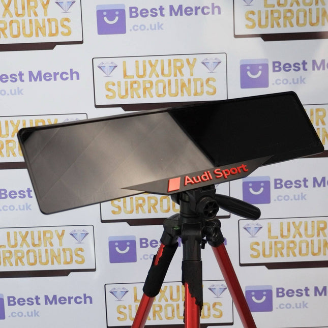 Red Audi Sport Plate Holder - Luxury Number Plate Holder displayed on a tripod stand, ideal for enhancing vehicle decor with sporty elegance.