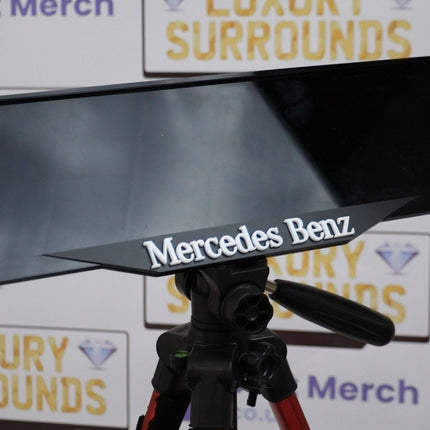 Close-up of White Mercedes Benz Plate Holder with 4D logo, showcasing sleek design and high-end finish for stylish license plate mounting.